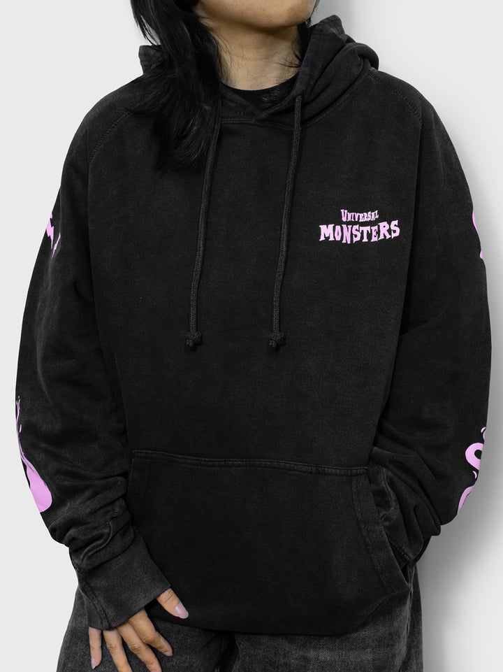 front of hoodie on model. front pocket. adjustable hood. universal monsters on left pocket.