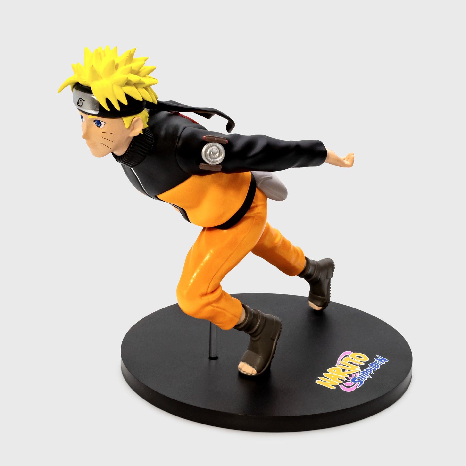 naruto in running position on stand vinyl figure. text on base: naruto shippuden