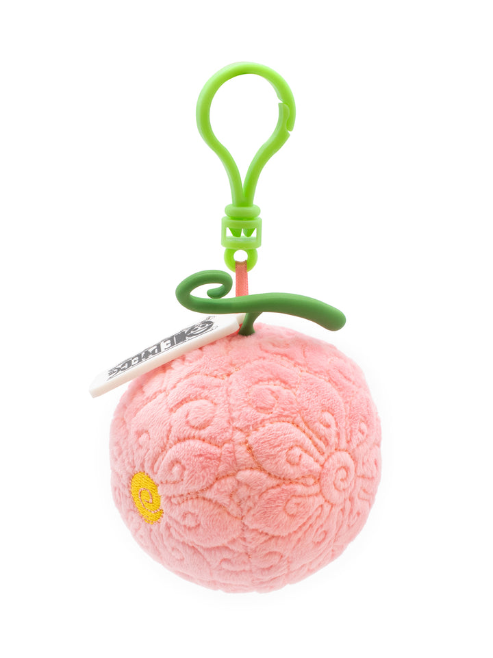 Pink textured ball keychain with green clip on a white background