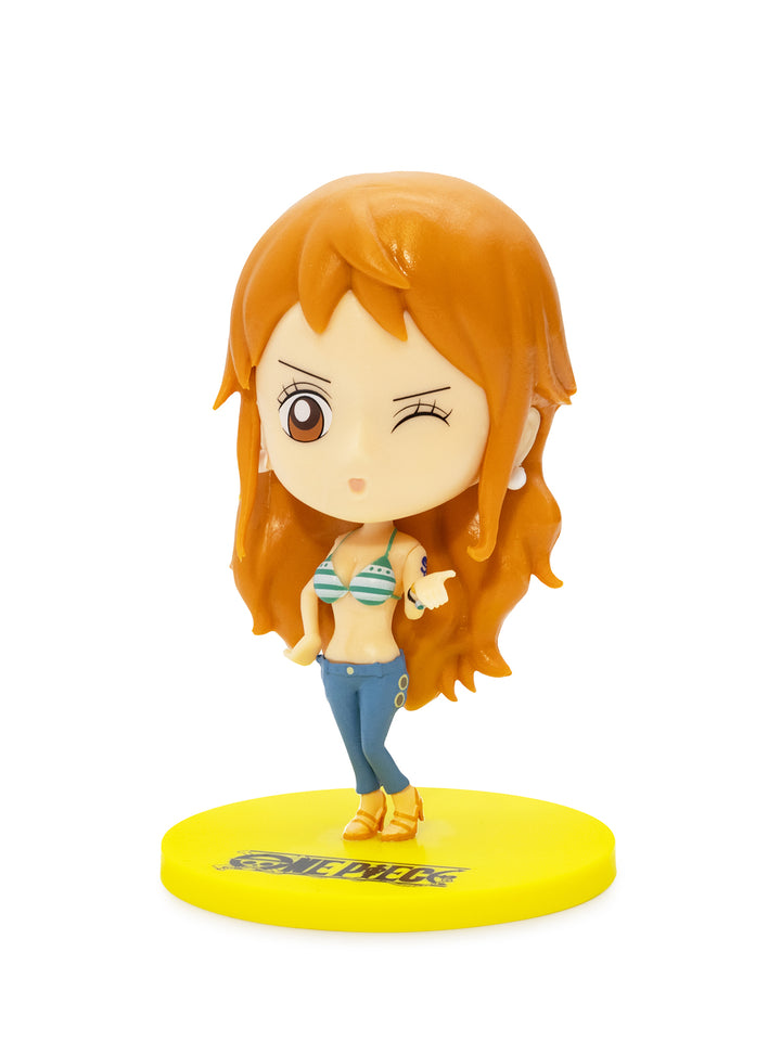 Small figurine of a character with orange hair on a yellow base against a white background