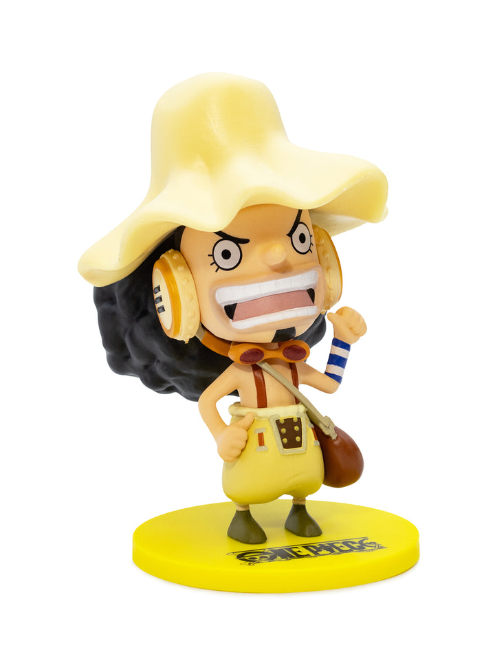 Figurine of a character from One Piece with a yellow hat and outfit on a white background