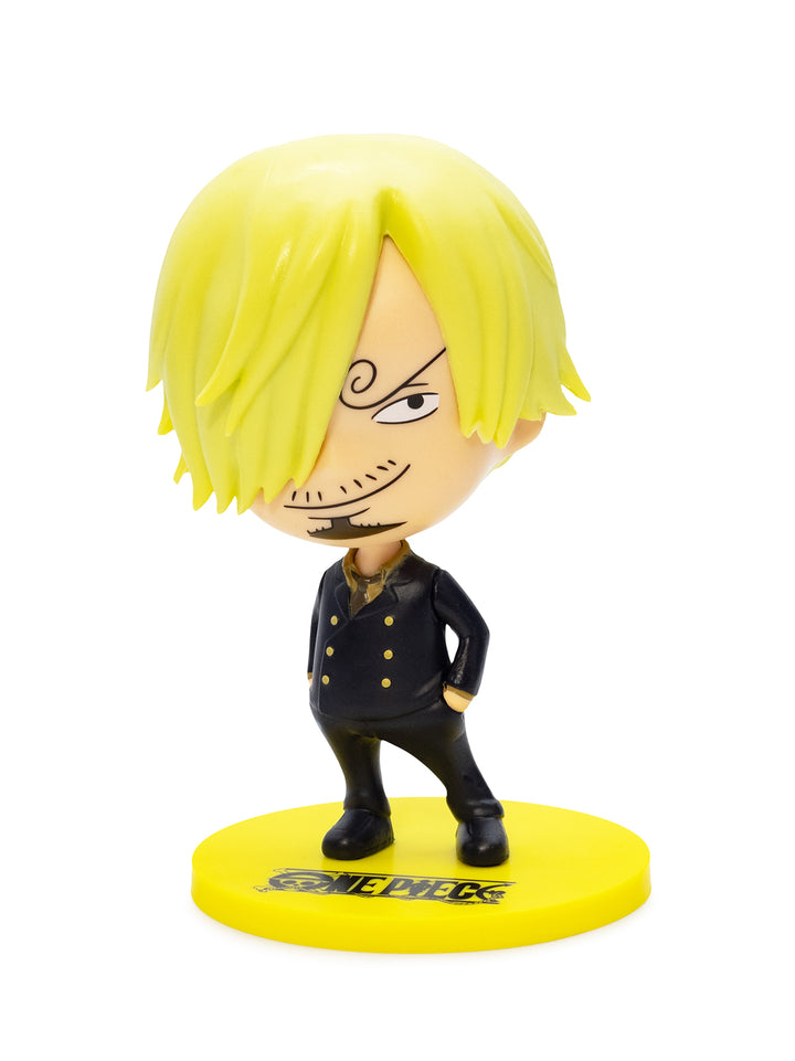 Figurine with blonde hair and black outfit on a yellow base with 'One Piece' branding