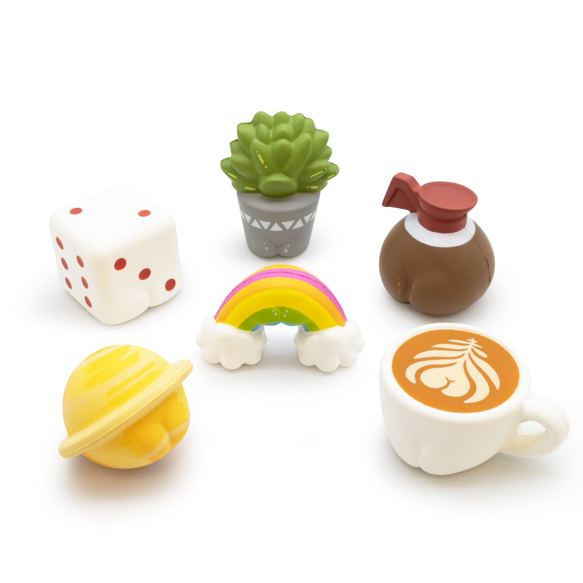 Set of colorful ceramic items including a dice, plant, rainbow, planet, and coffee cup on a white background