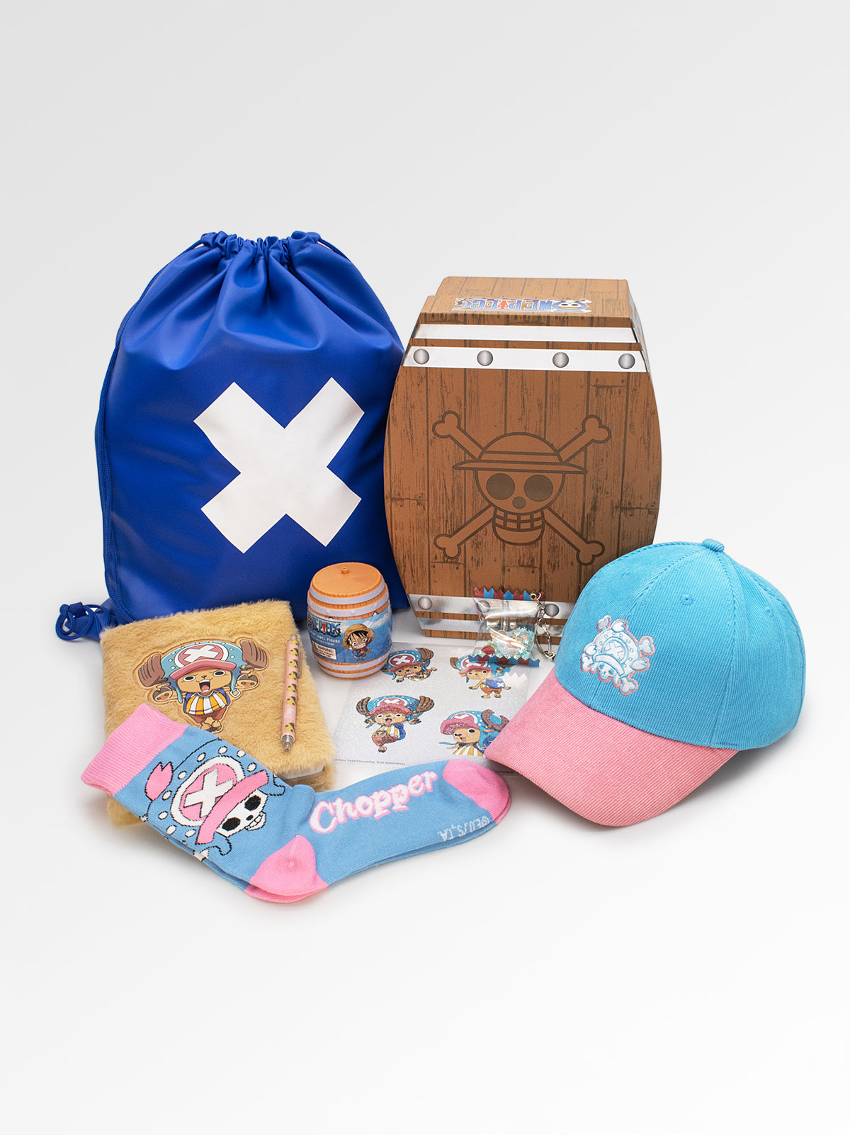 Collection of merchandise including a blue drawstring bag, cap, socks, and a wooden chest with a pirate design on a white background.