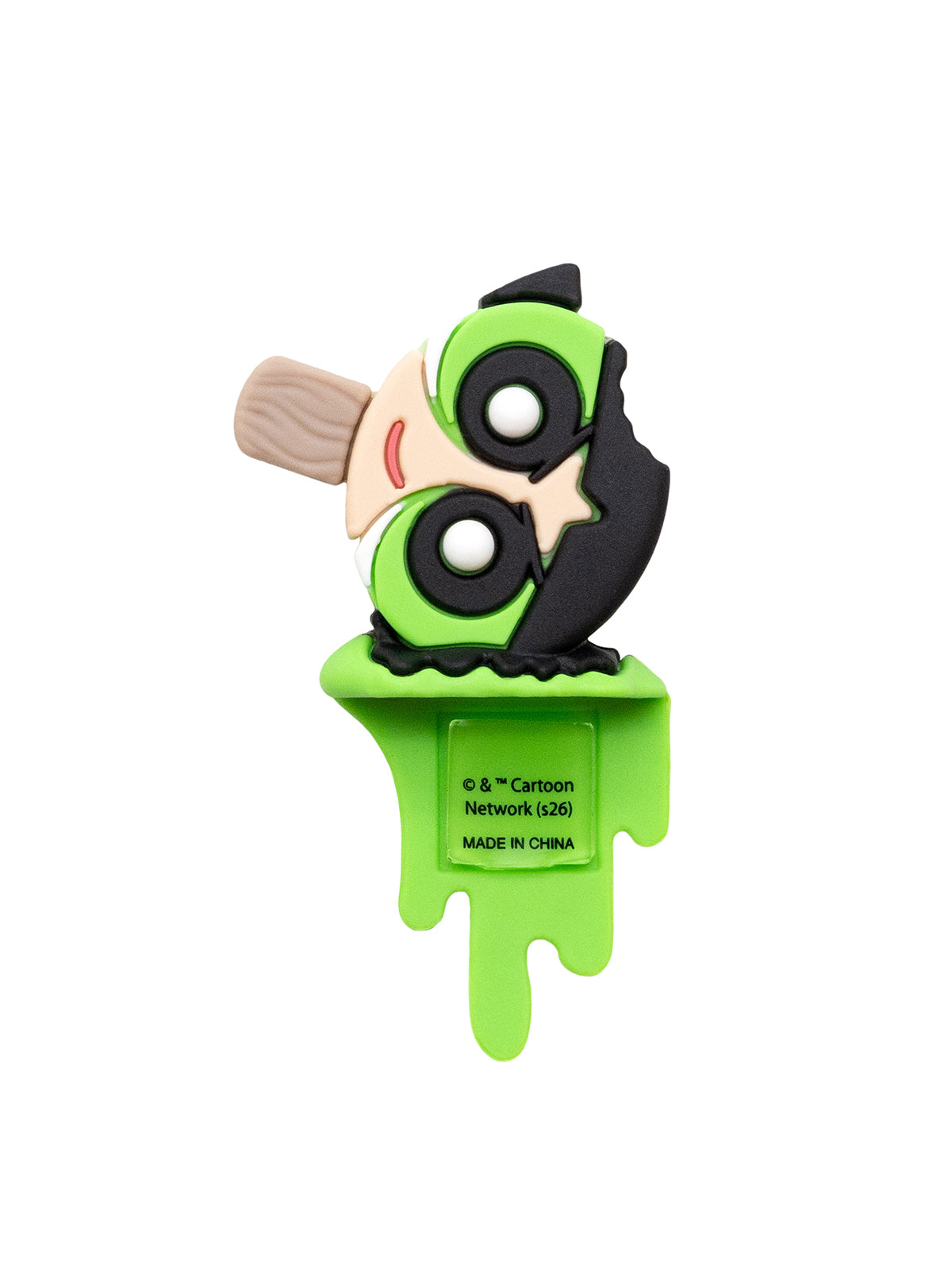 A green and black cartoon character novelty item with a beige stick, mounted on a bright green melting base