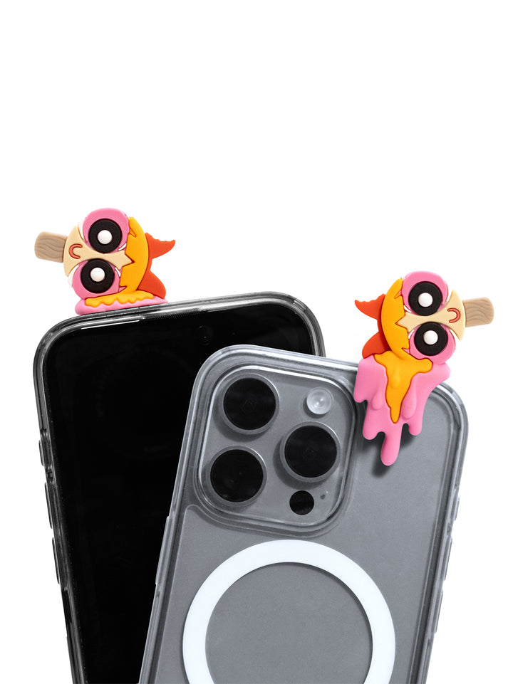 Two clear phone cases with colorful cartoon charms on the back, shown on black smartphones against a white background.