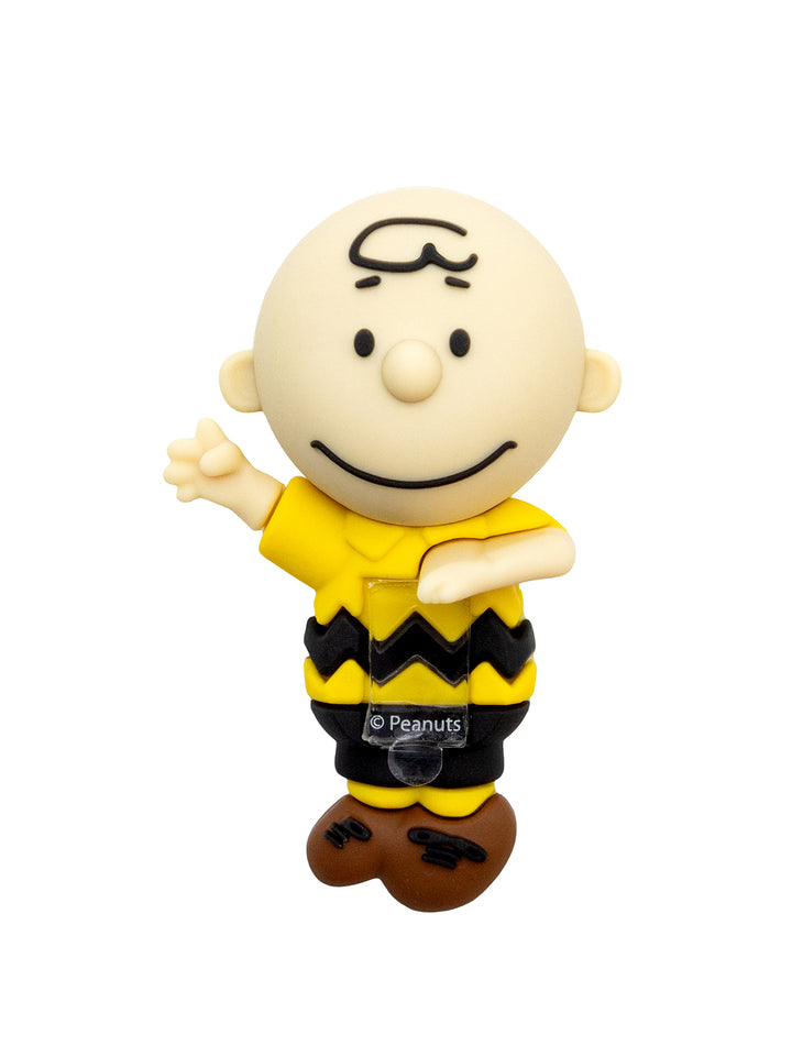 A Charlie Brown collectible figure from Peanuts, featuring the character in his signature yellow shirt with a black zigzag pattern, black pants, and brown shoes, set against a plain white background.