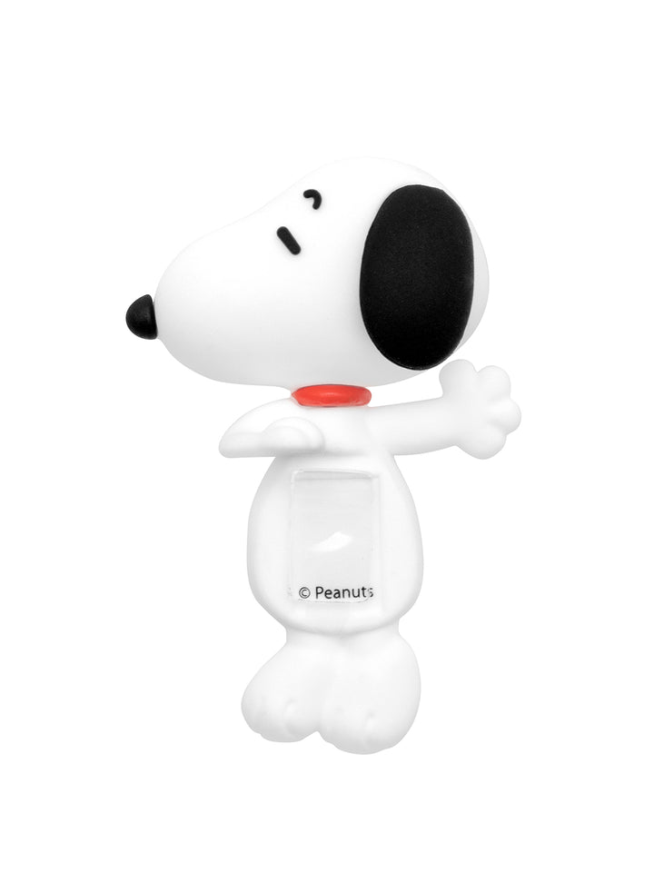 A white Snoopy character figure with a black nose and ear, a red collar, and a clear front window showing a small Peanuts copyright mark, on a solid white background.