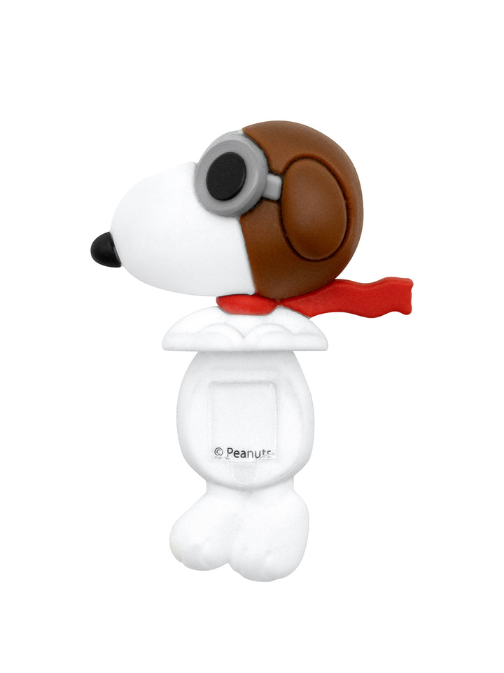 A white and brown Snoopy dog-shaped figure with a brown aviator helmet, gray goggles, and a red scarf, shown on a plain white background. A small 'Peanut' copyright mark is visible on the front.