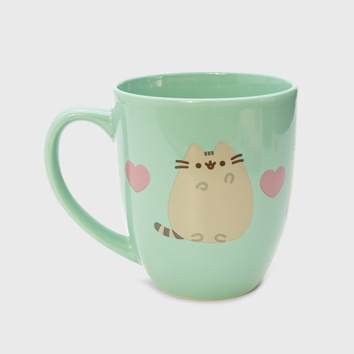 one side of mug. pusheen waving. 2 hearts.