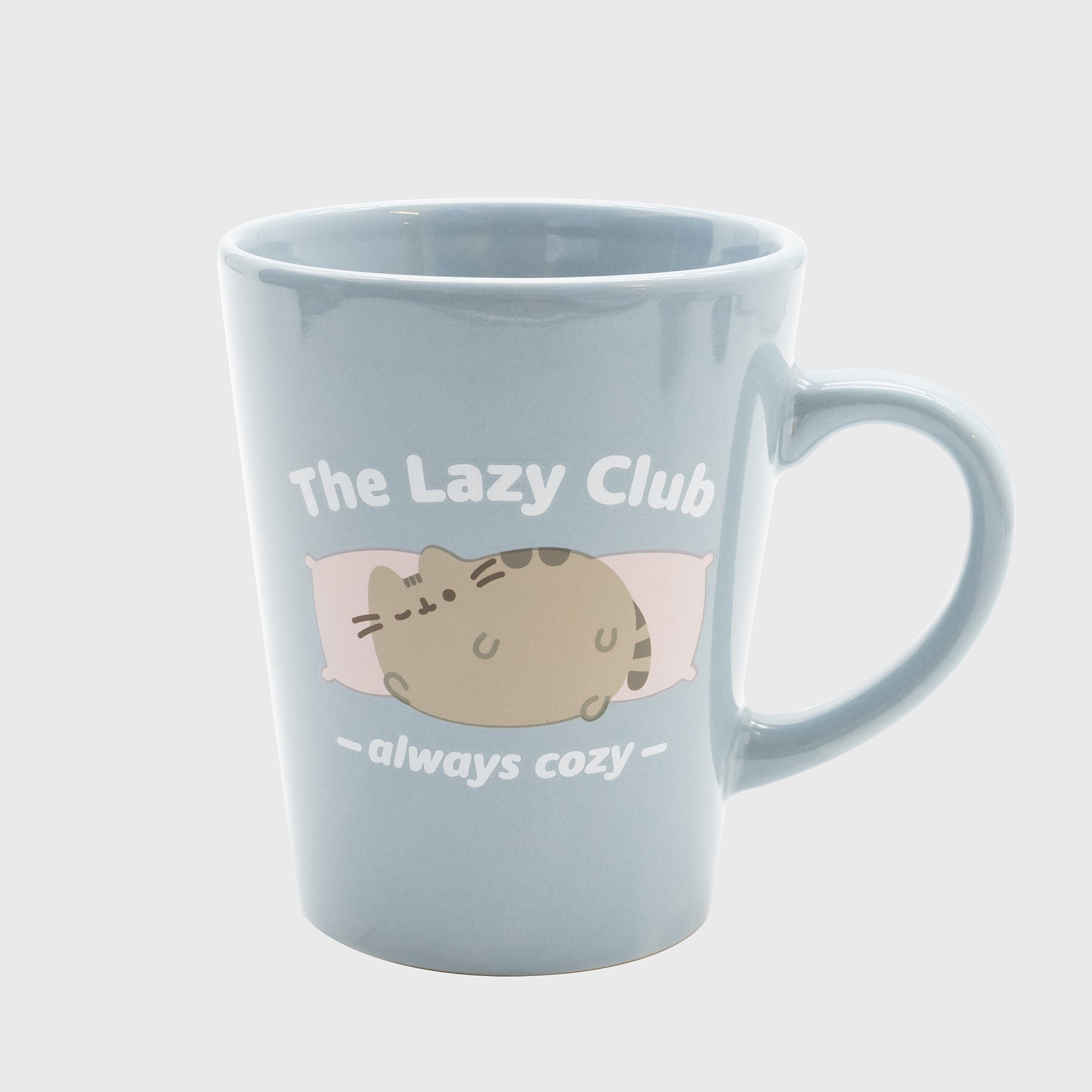 pusheen mug. pusheen laying on two pillows. text: the lazy club always cozy