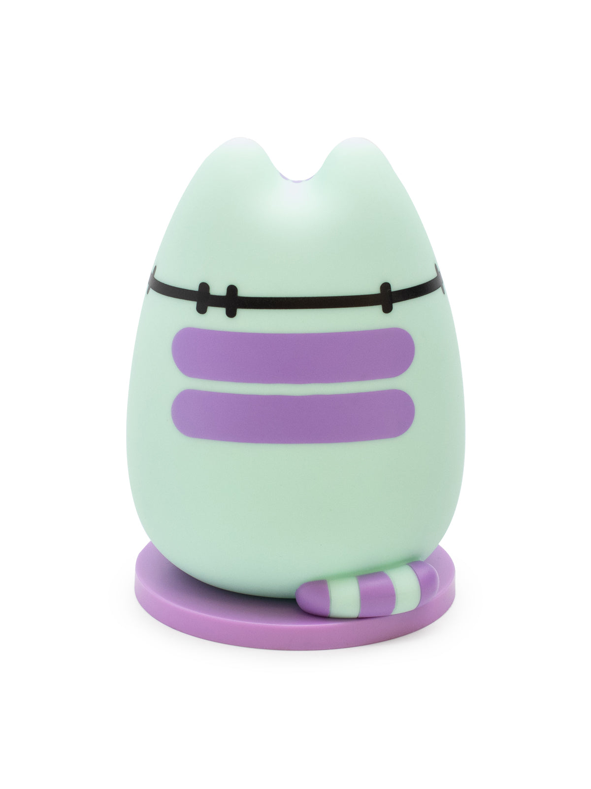 A cute, egg-shaped cat figurine in mint green with purple stripes, a black belt, and a small striped tail, standing on a purple circular base against a white background.