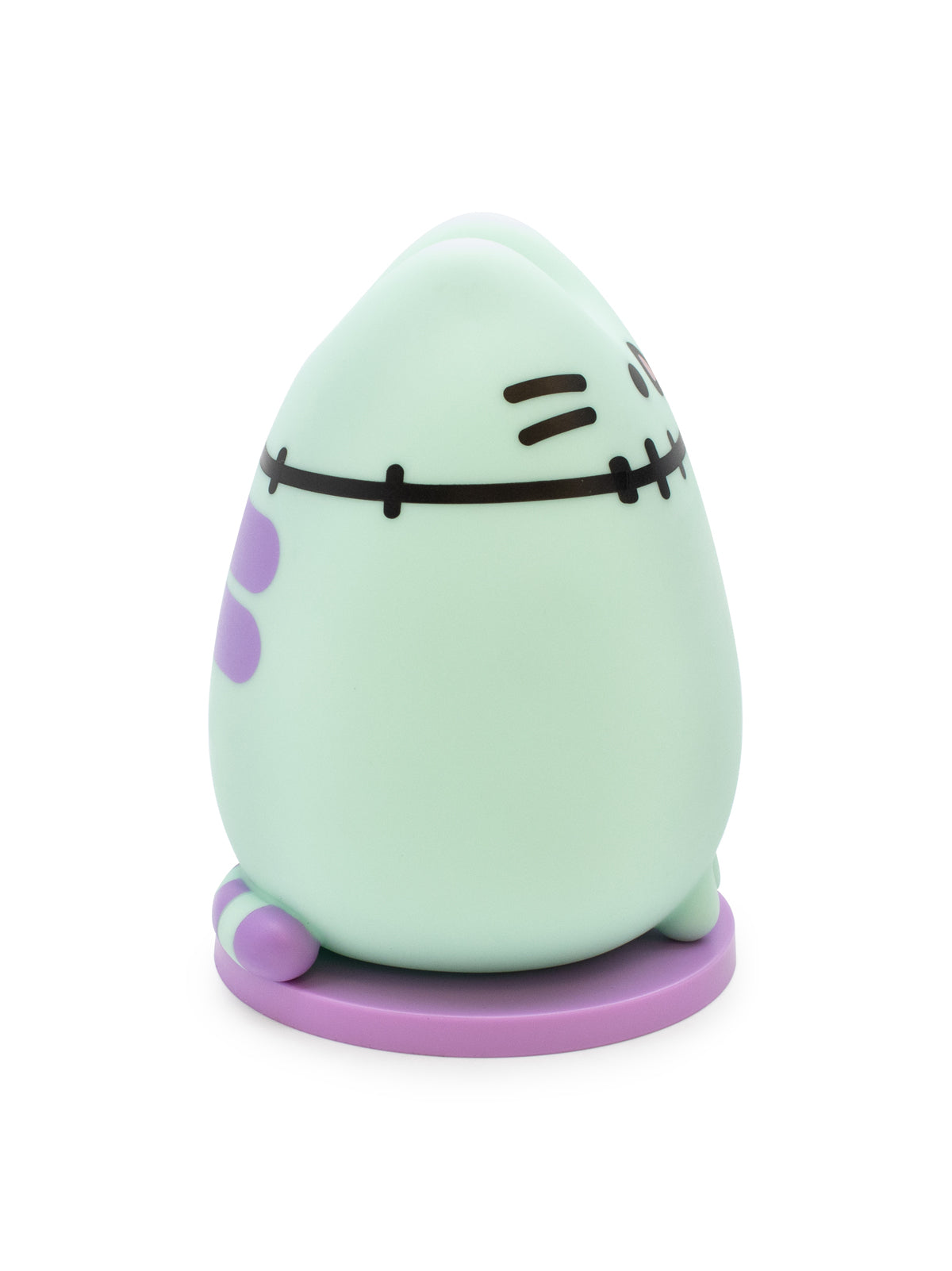 A cute, egg-shaped character figurine in a pale mint green color with purple accents and black stitched facial features, standing on a round purple base against a white background.