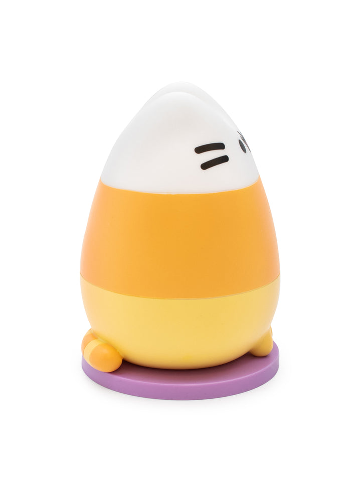 A small egg-shaped character figurine with a white top section, orange middle band, pale yellow lower section, and a purple circular base, shown on a plain white background.