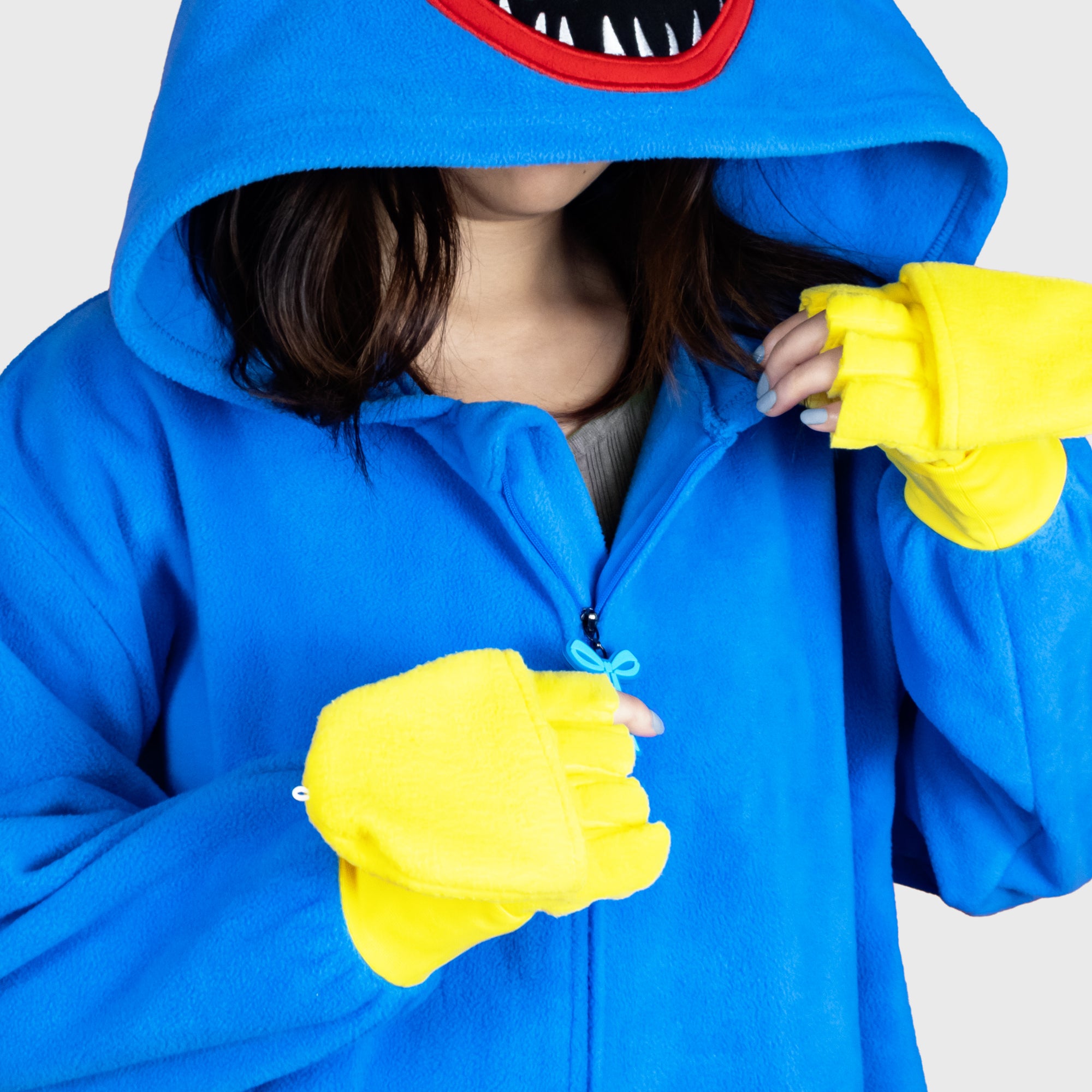 huggy wuggy onesie zips up on front. zipper has little bow tie on it. hands convert from mittens to fingerless gloves.