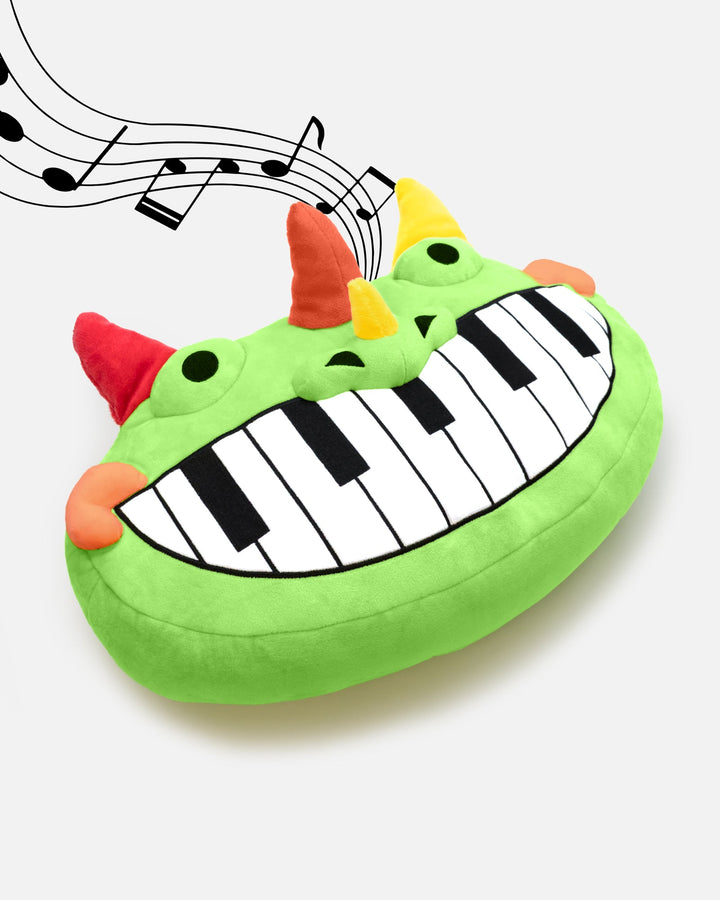 pianosaurus pillow plush with music notes. plush plays music