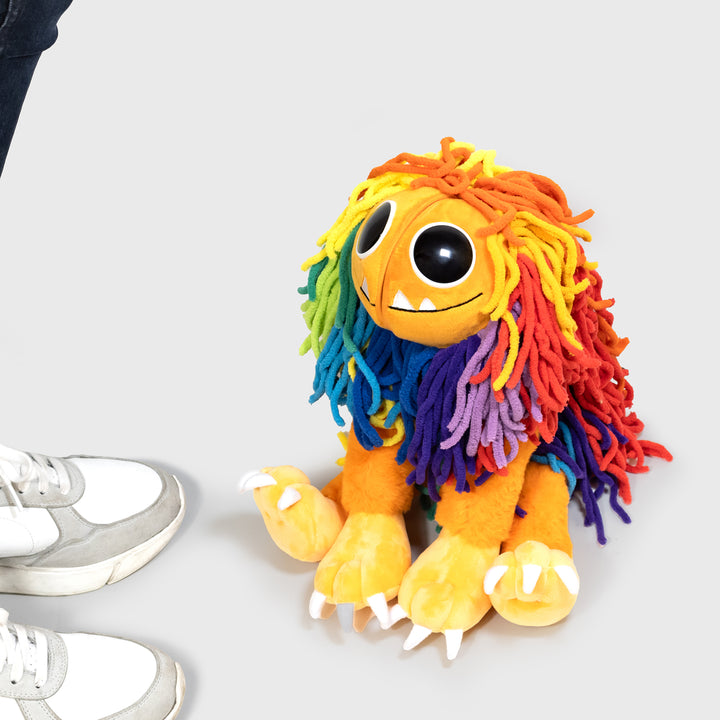 yarnaby plush sitting on floor