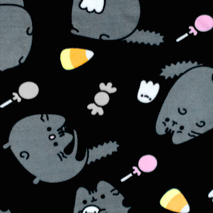 close up of throw blanket. repeating pattern of scaredy pusheen, ghost, candy corn, candy, lollipop