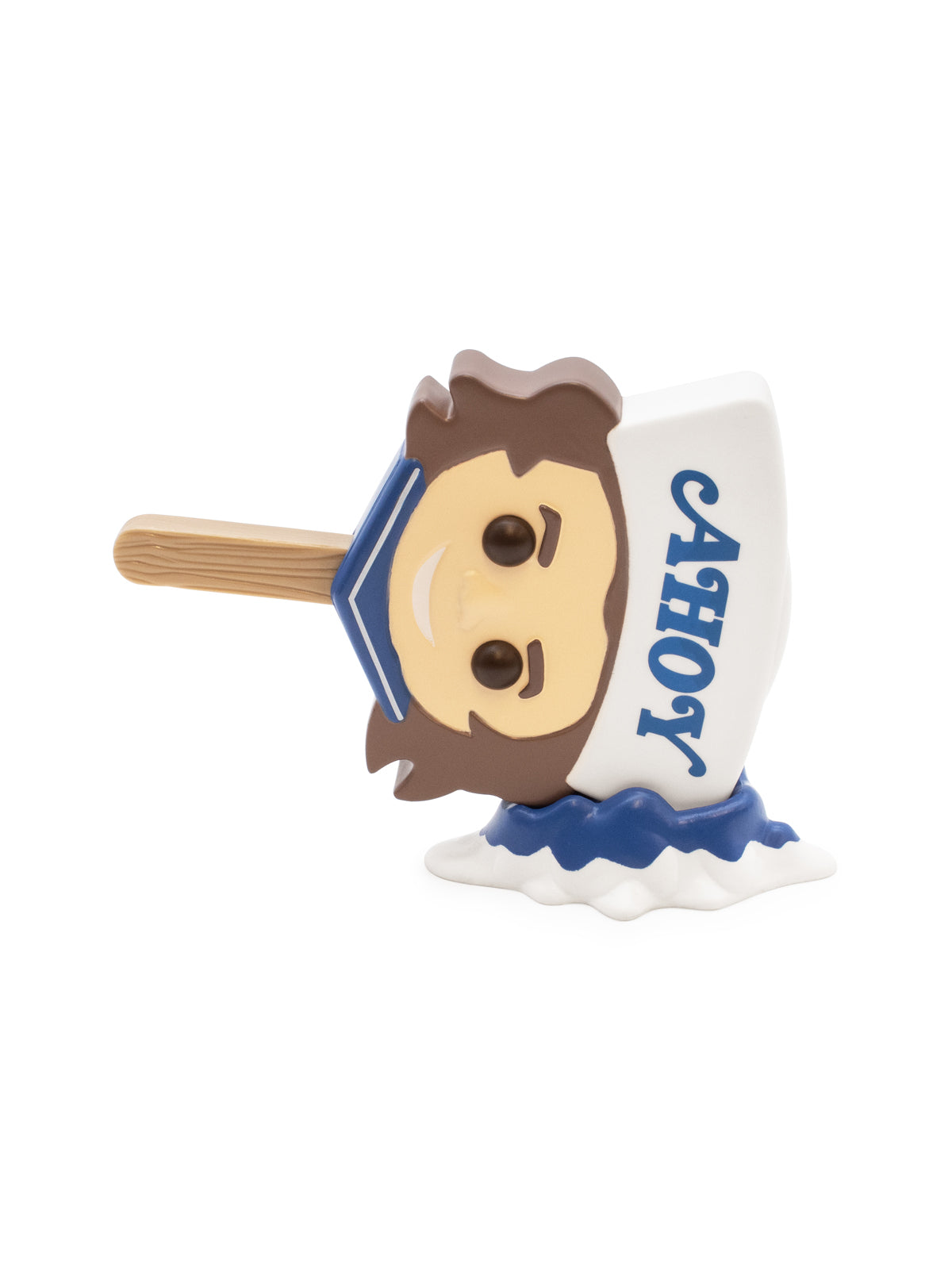 Toy figure of a man with hair with a sailer hat that says ahoy on a white background