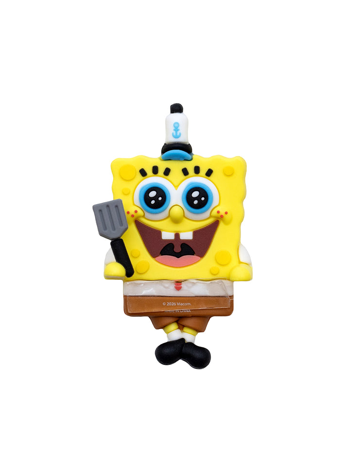 A SpongeBob SquarePants character figurine wearing his krusty krab hat and holding a spatula, isolated on a white background.