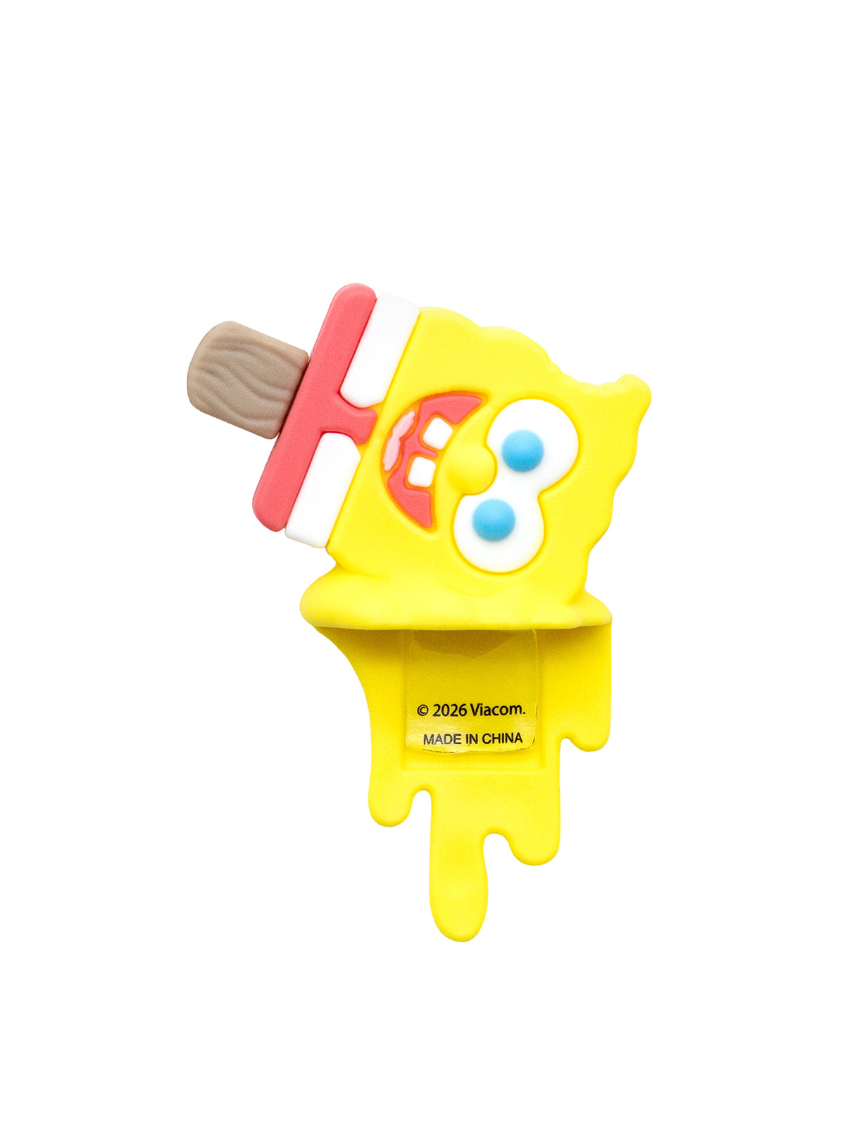 A yellow popsicle-shaped novelty item featuring SpongeBob SquarePants facial features on a wooden stick