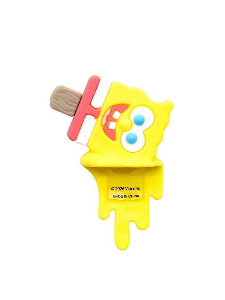 A yellow popsicle-shaped novelty item featuring SpongeBob SquarePants facial features on a wooden stick