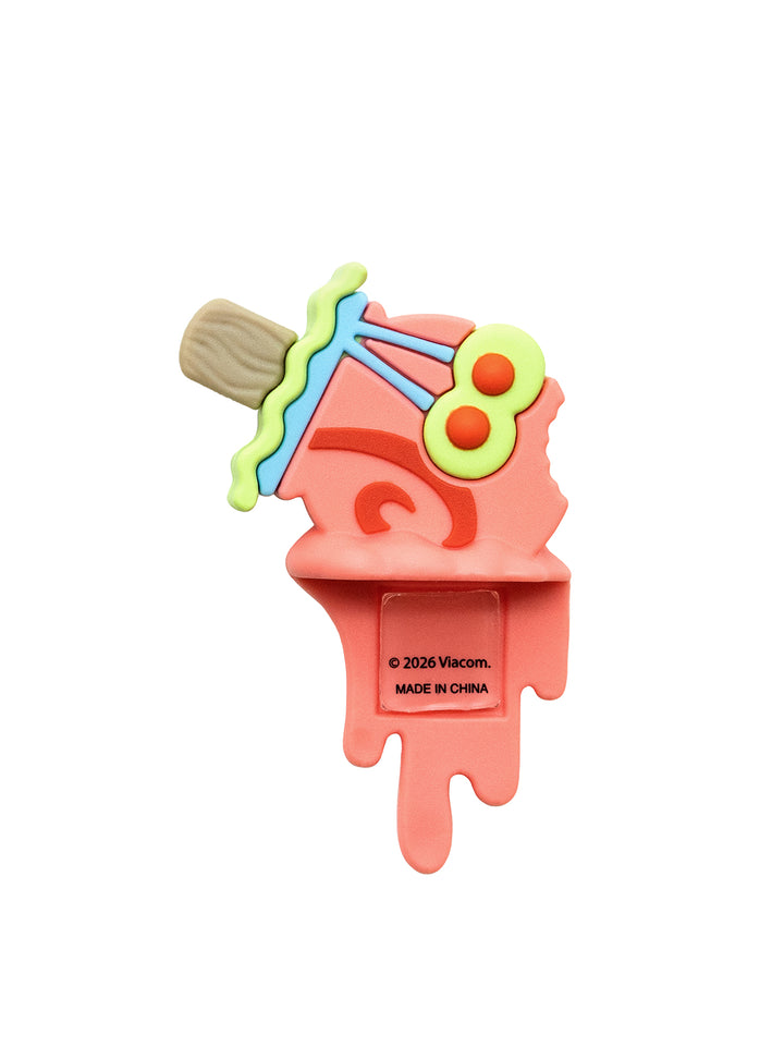 A coral pink silicone phone figure shaped like melting ice cream, featuring a light brown wooden stick, light blue wavy trim, lime green details, and red dots