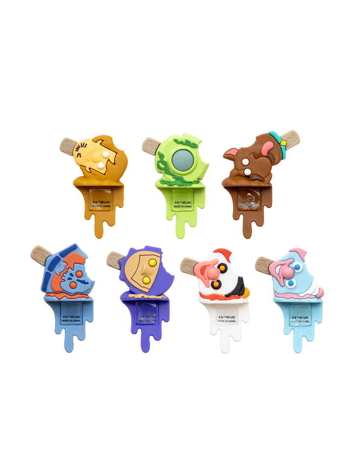 Seven cartoon-style popsicle-shaped items arranged in two rows on a plain white background. Each popsicle has a different character design in colors including yellow, green, brown, blue, purple, white, pink, and orange.