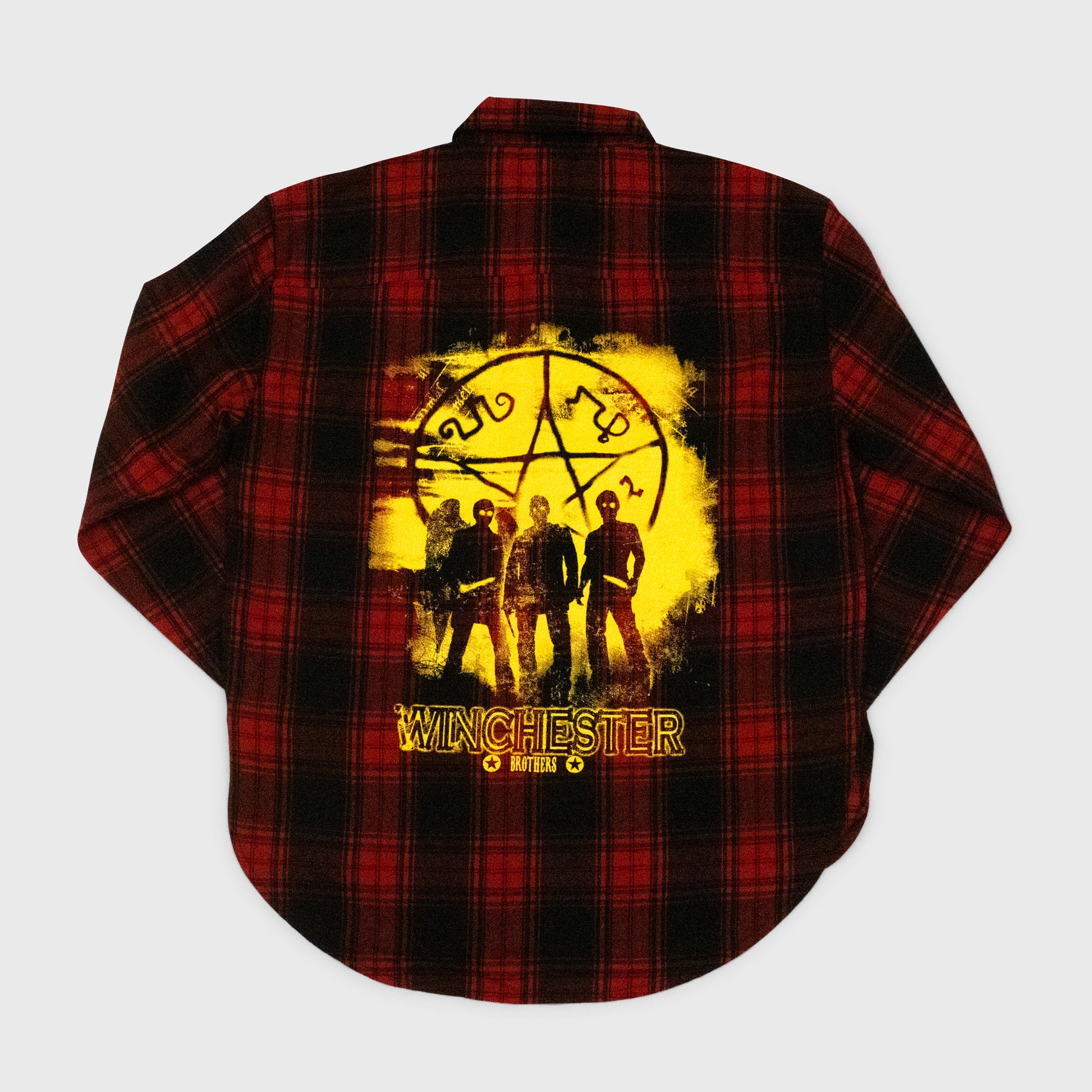 plaid shirt back. image: 3 men with pentagram symbol. text: winchester brothers