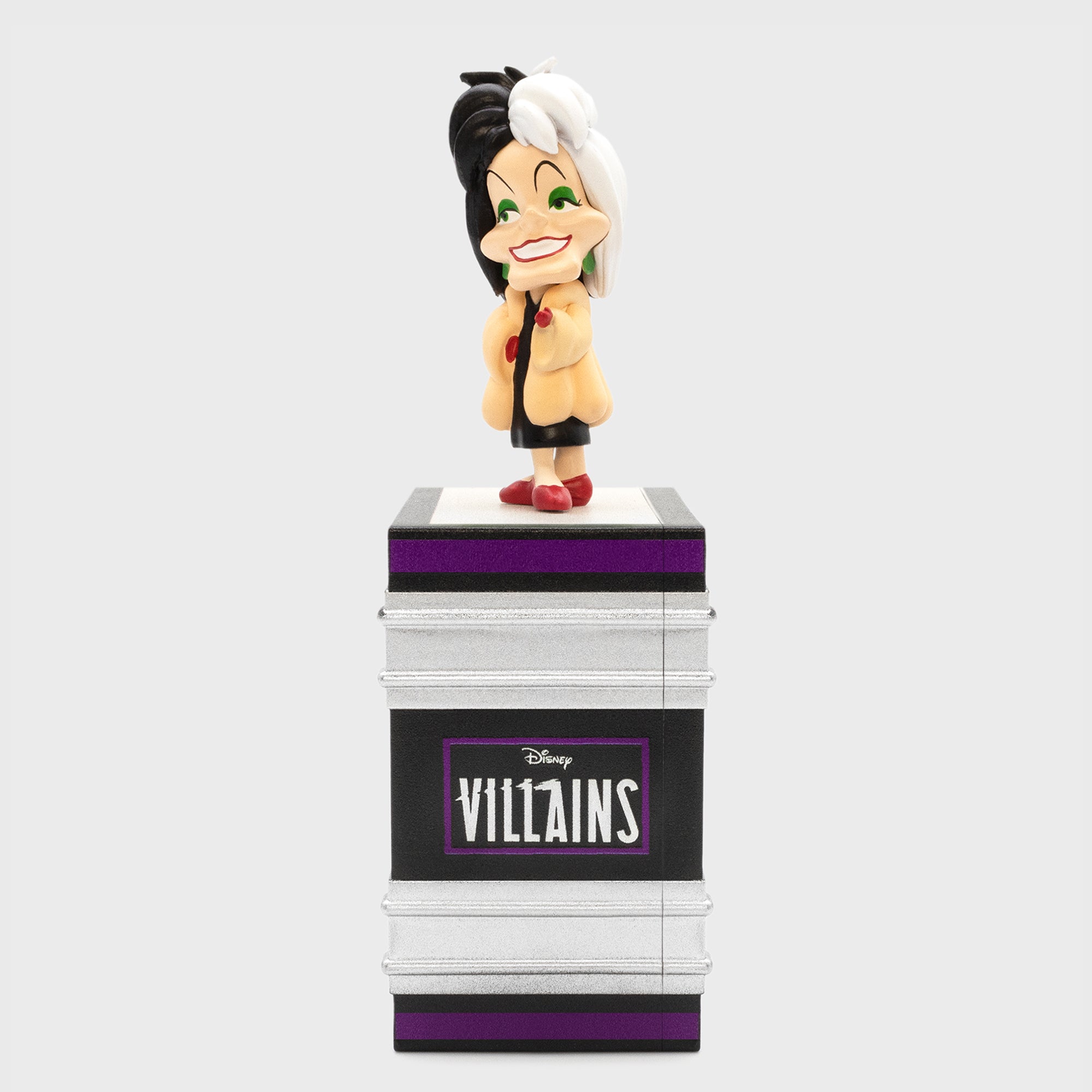 cruella de vil on top of book