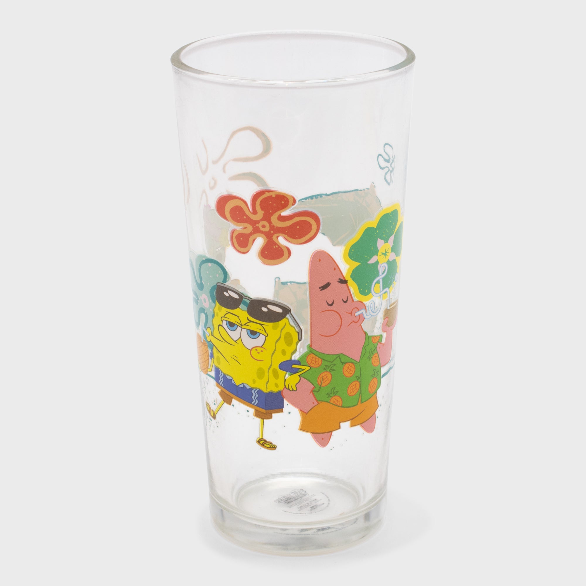 spongebob squarepants tall drinking glass. image: spongebob and patricks wearing vacation clothes drinking out of coconuts, flowers.
