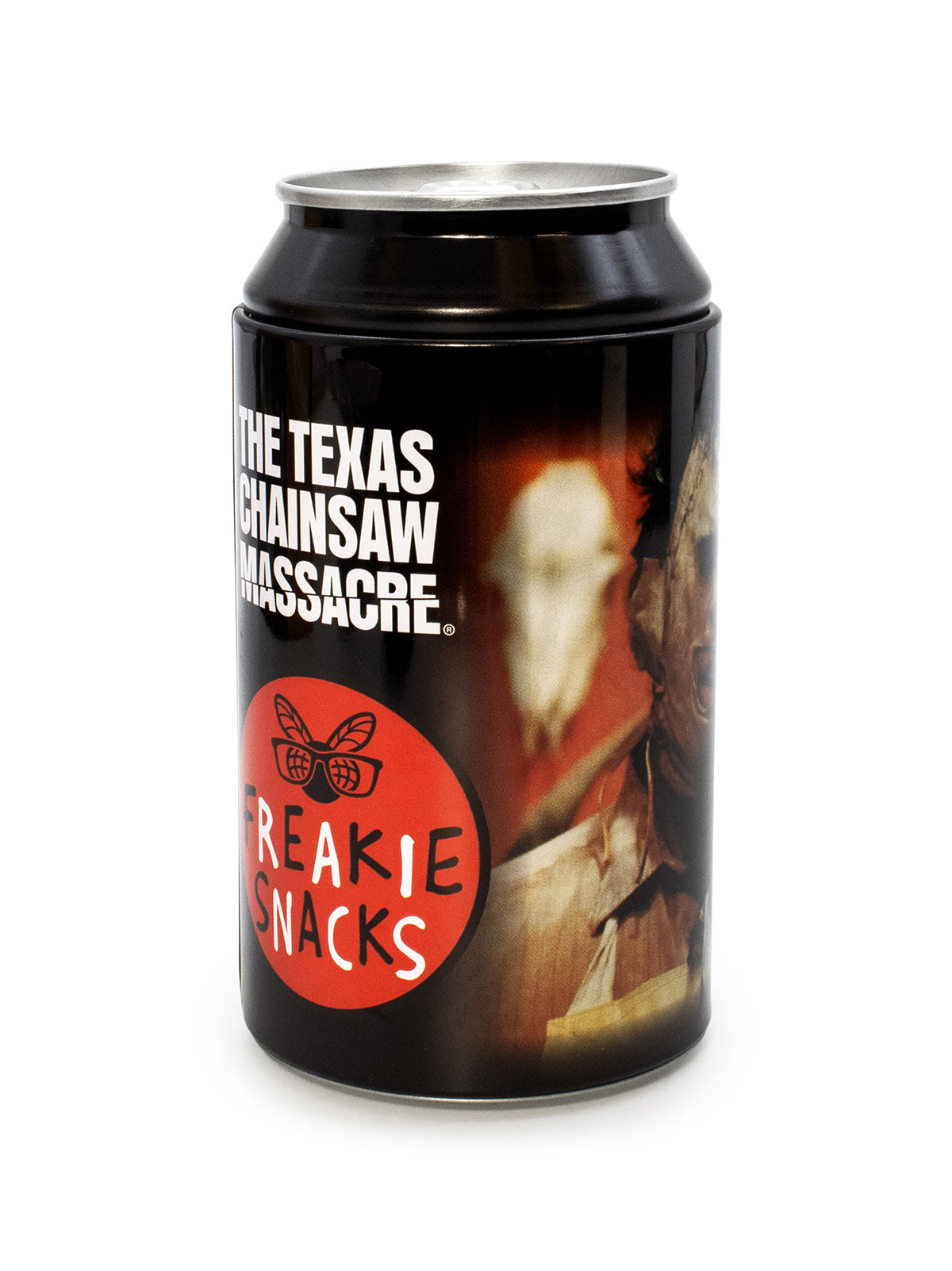 A black metal beverage can with a printed horror-themed label featuring the text 'THE TEXAS CHAINSAW MASSACRE' and a red circle with 'FREAKIE SNACKS' and a bee logo, photographed on a white background.