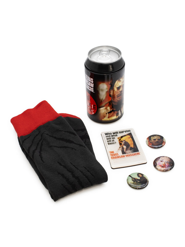 A themed merchandise set featuring a black and red sock, a black can cooler with a movie still, a printed card, and three round pin-back buttons on a white background