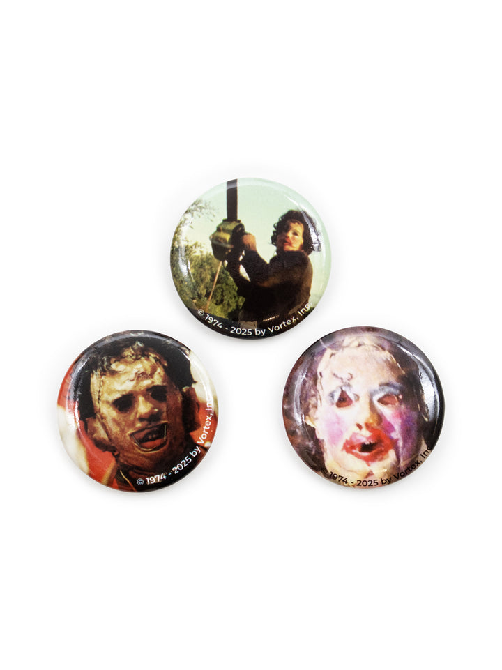 Three round pin-back buttons featuring horror movie stills, including Leatherface, shown on a plain white background.