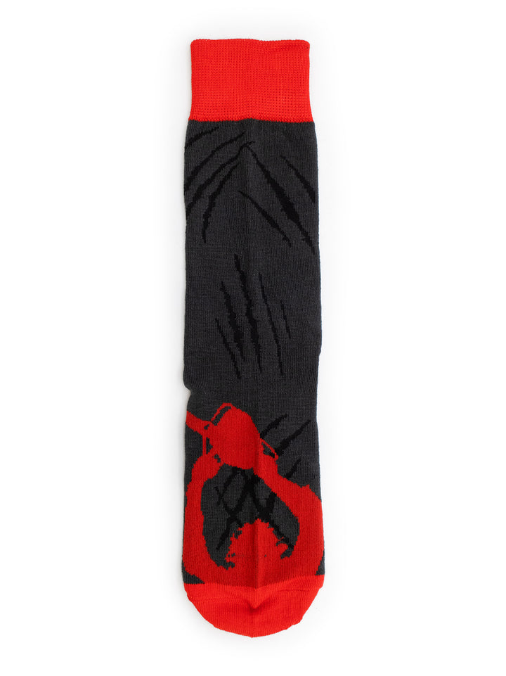 A single crew sock with a black body featuring a red claw pattern, a solid red cuff, and a red toe, displayed flat against a white background.