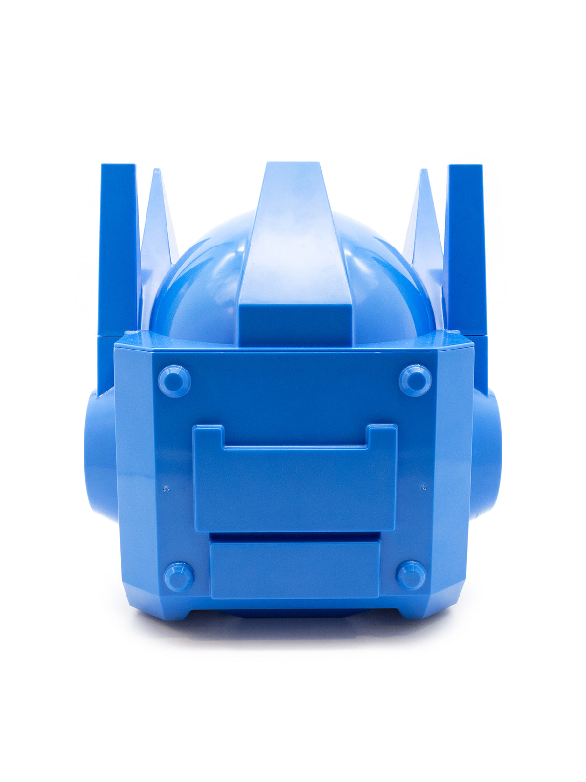 A bright blue plastic toy or model accessory with a rounded dome top, vertical side fins, and a front panel with molded details, photographed on a clean white background.