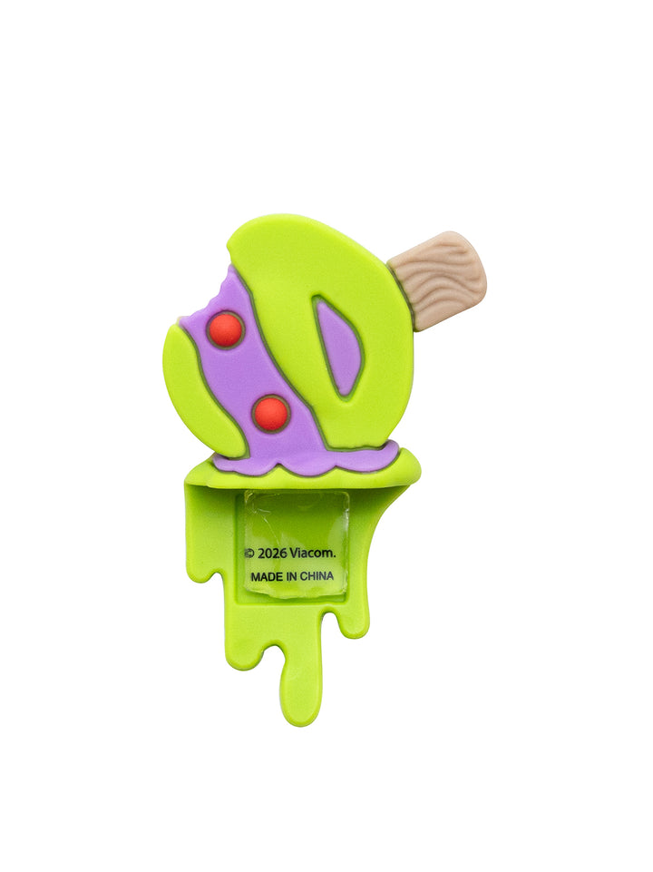 A novelty figure shaped like a melting popsicle, featuring a bright lime green body, purple mask, red eyes, and a light brown wooden stick handle