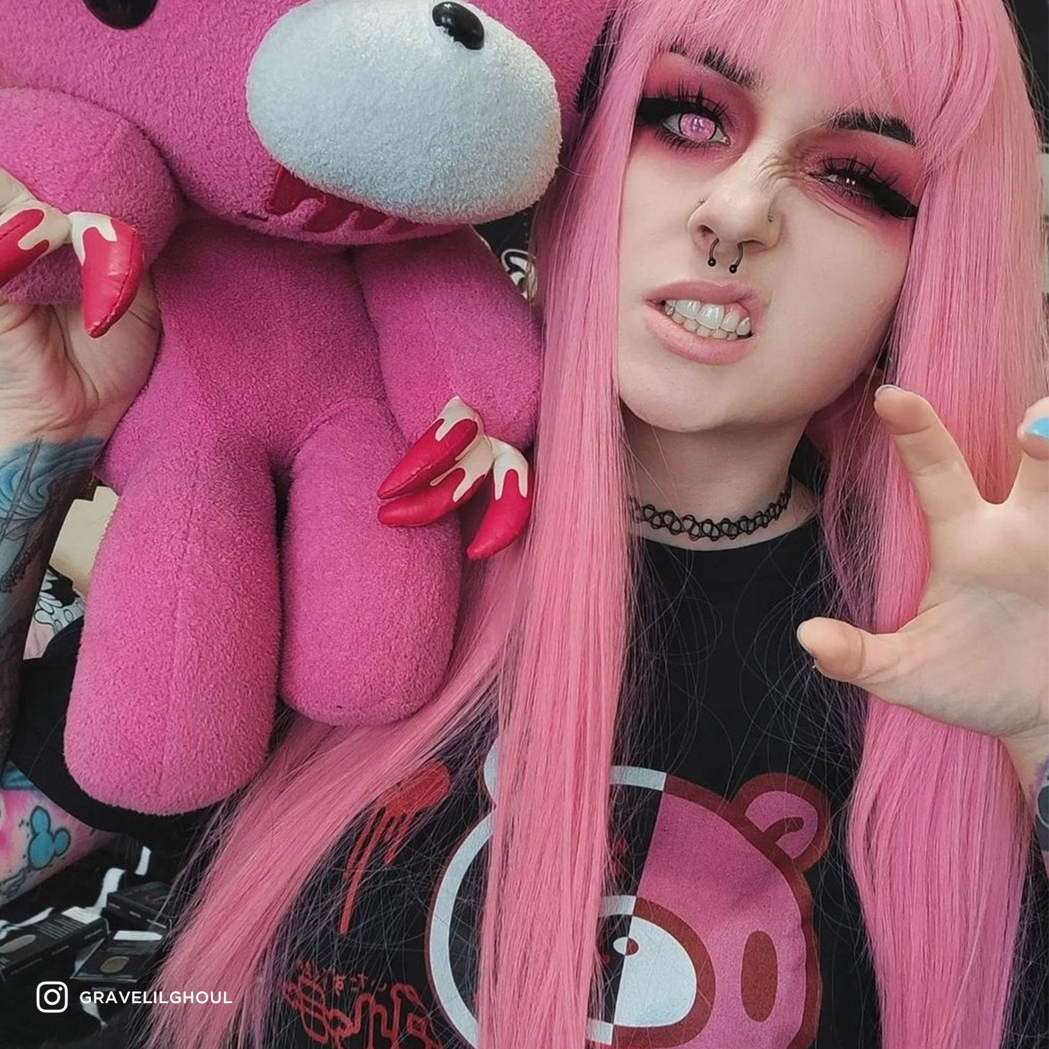woman holding plush and wearing shirt.