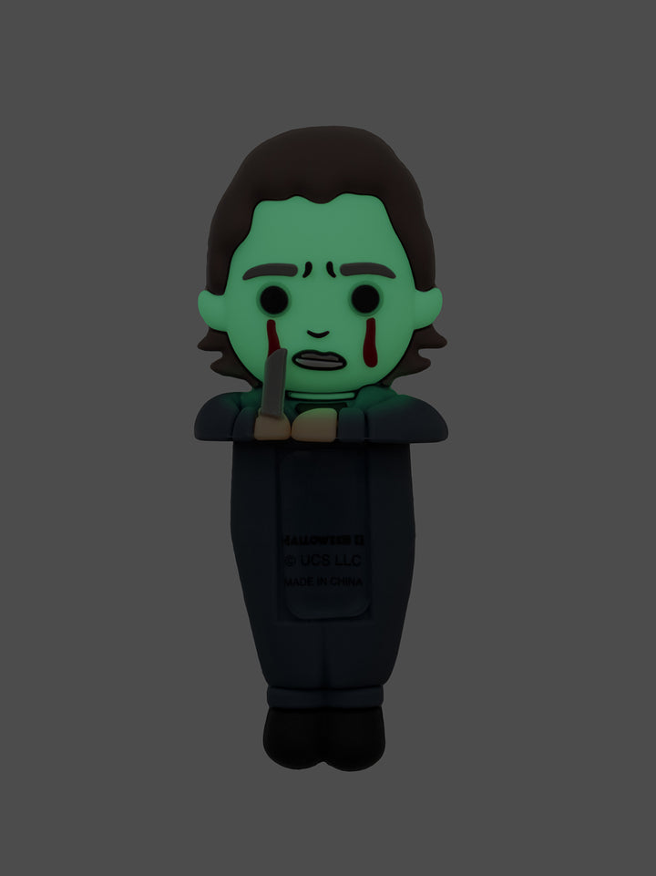 Character figurine with green face and black clothing on a gray background