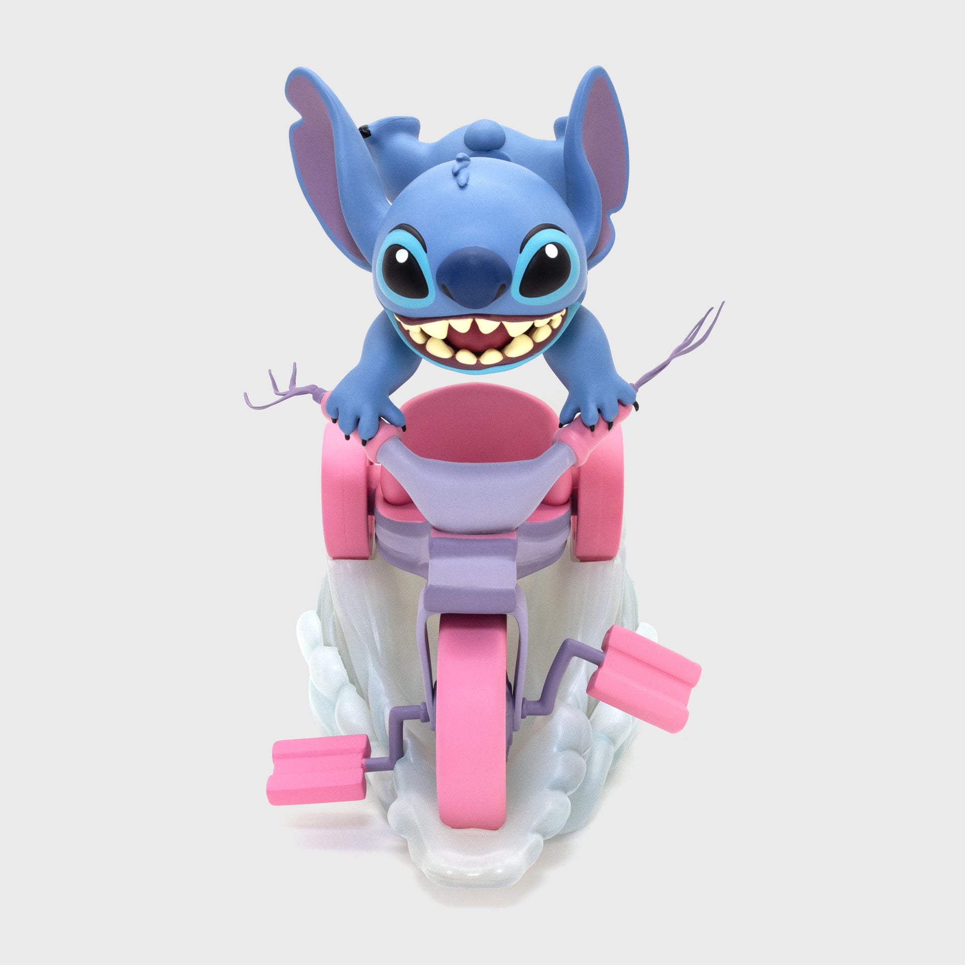 stitch riding on tricycle facing forward.