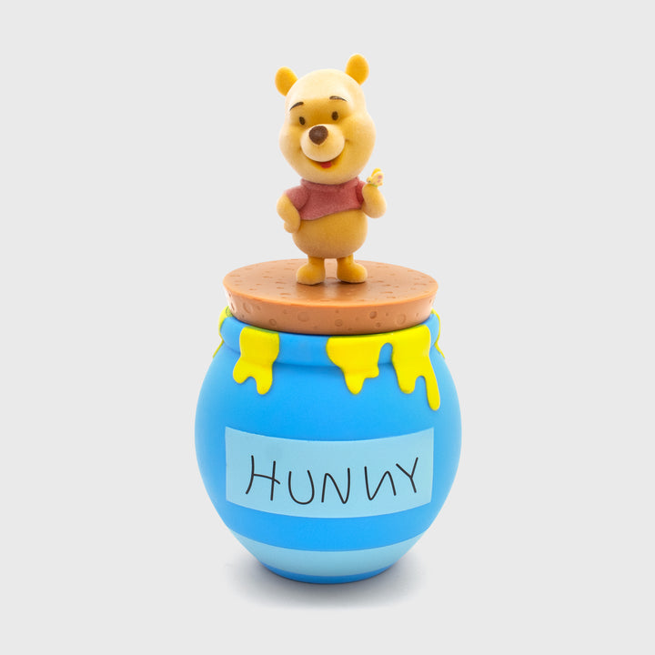 flocked pooh holding butterfly on top of hunny pot