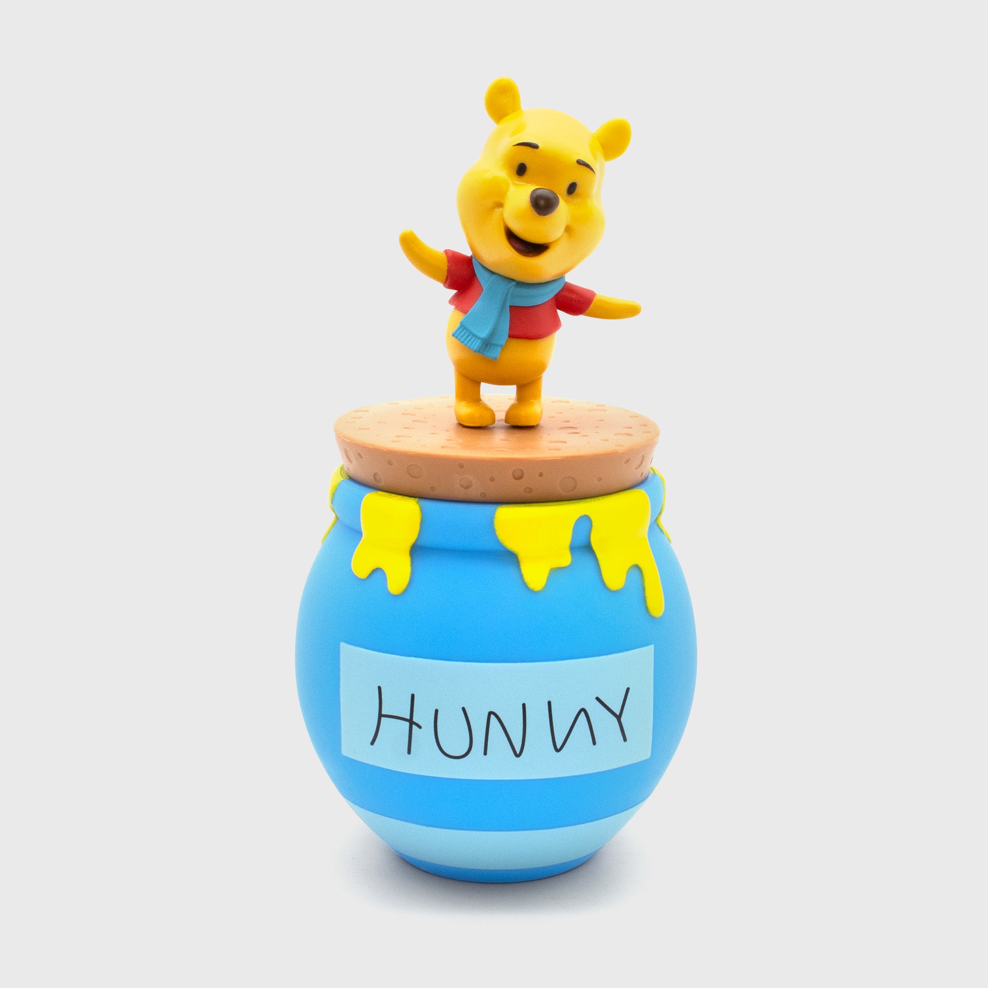 pooh wearing scarf on top of hunny pot