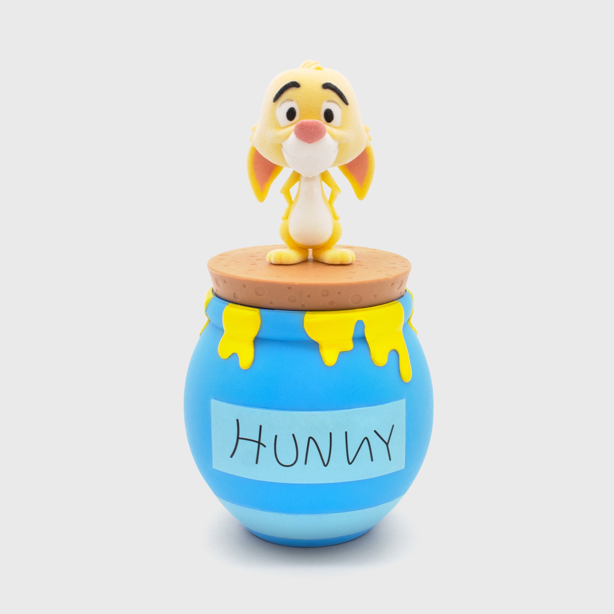 flocked rabbit on top of hunny pot