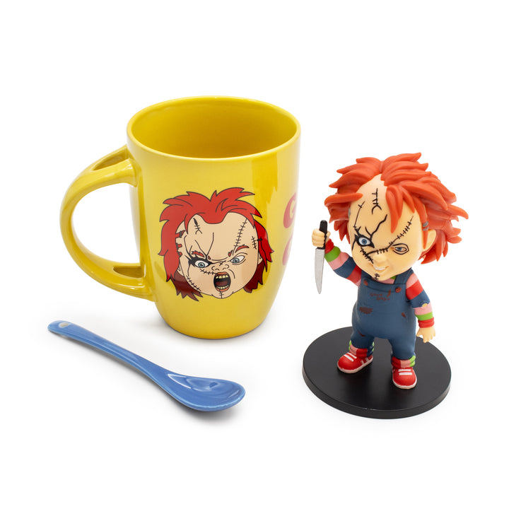 Yellow mug with Chucky design, Chucky figurine, and blue spoon on a white background