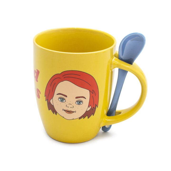 Yellow mug with a face design and a blue spoon on a white background