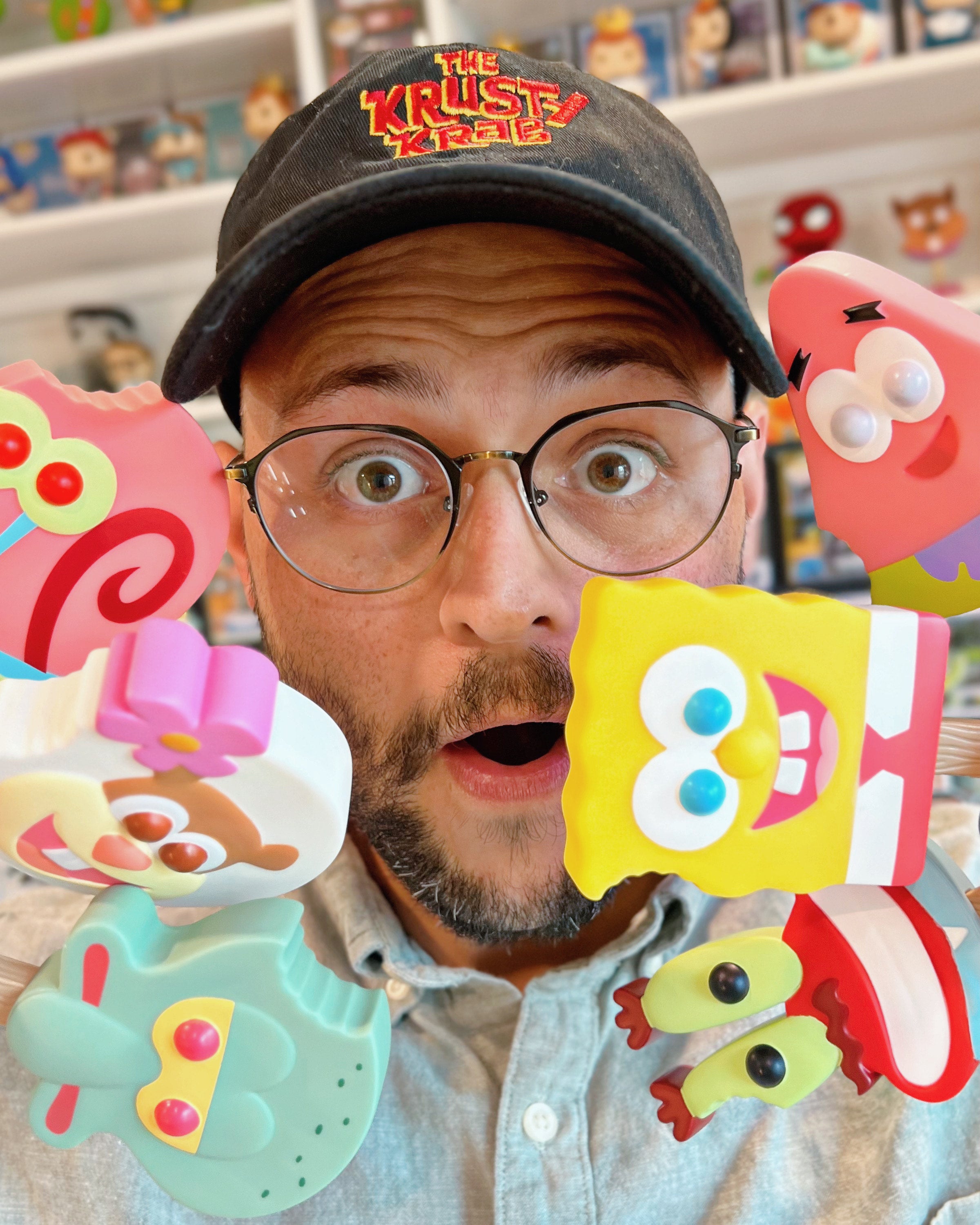 Person wearing a 'The Krusty Krab' cap with colorful props in a store setting