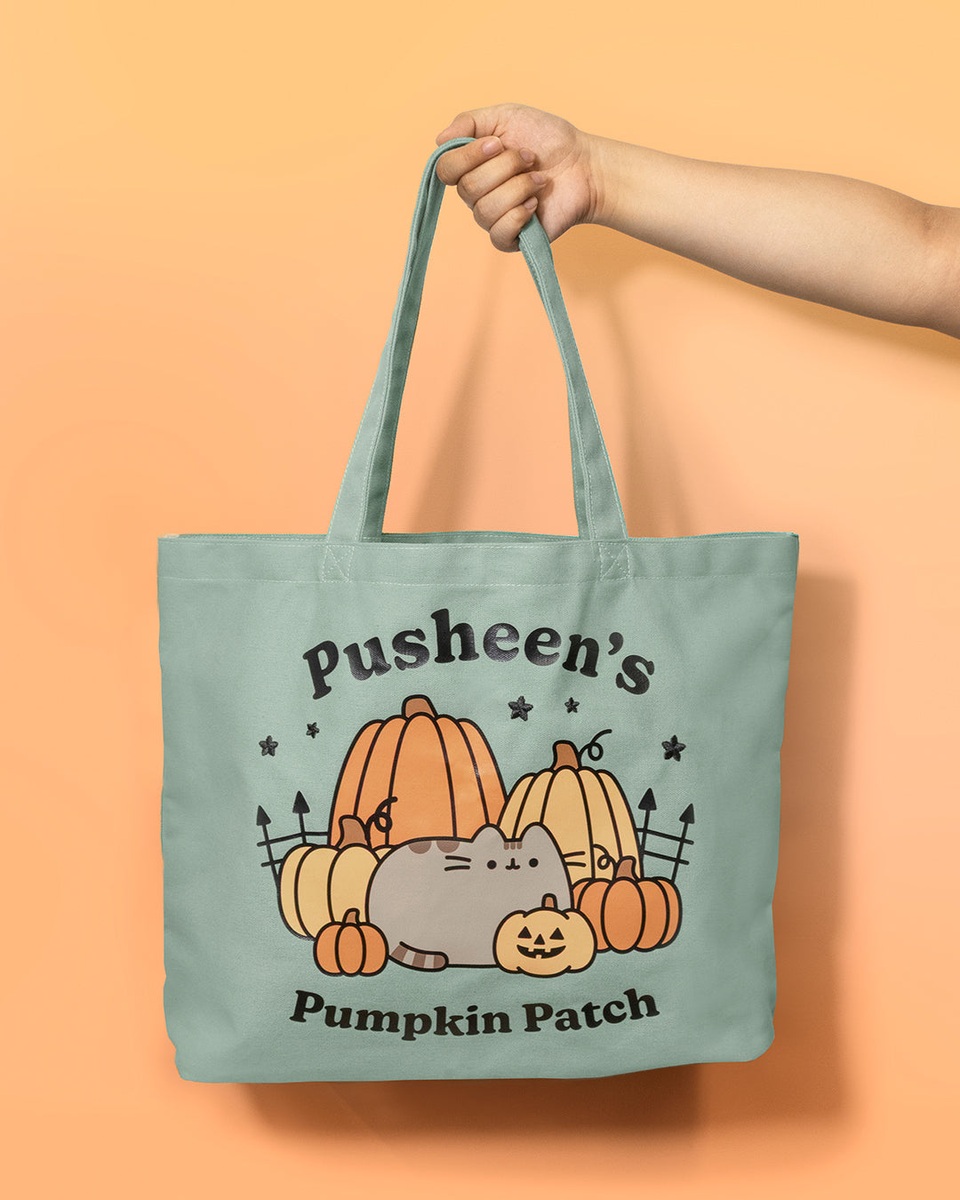 Tote bag with 'Pusheen's Pumpkin Patch' design on a peach background