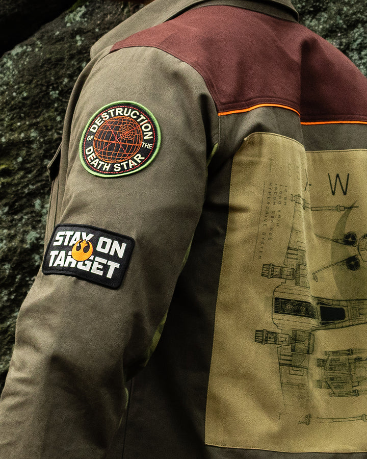 Close-up of a jacket with patches and designs, including a Star Wars-themed patch.