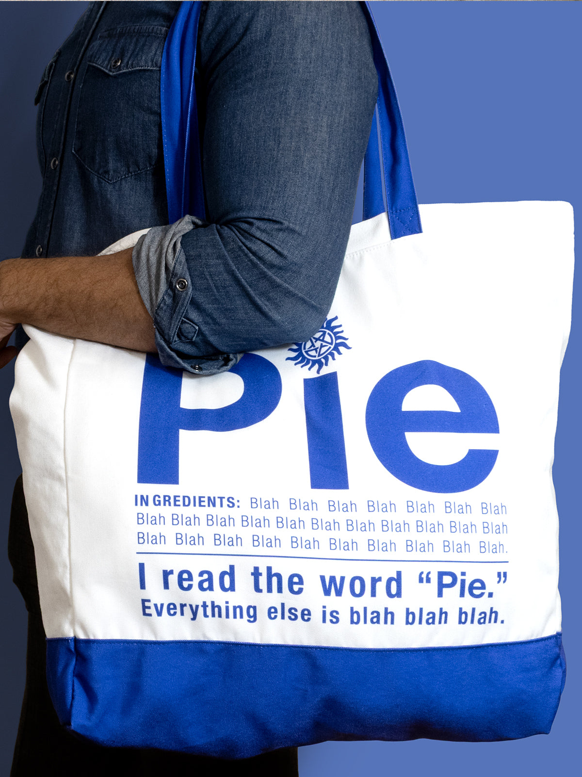Tote bag with humorous text design on a blue background