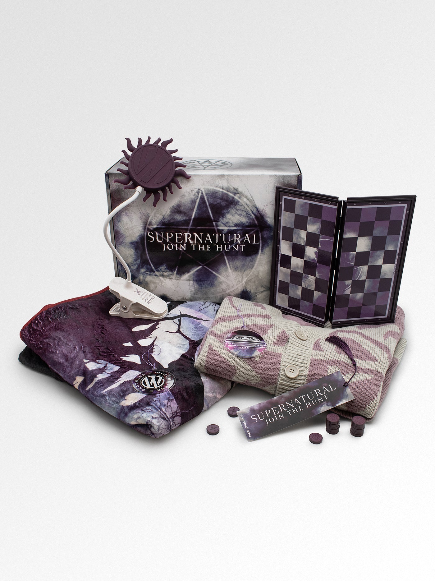 Supernatural-themed product set including a box, checker board, and socks on a light gray background.